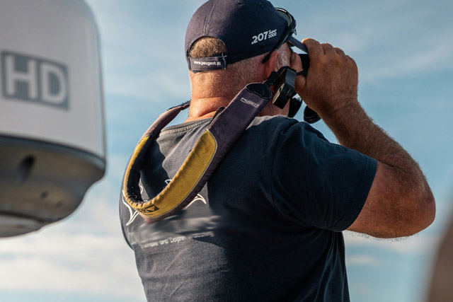 Whale watcher using binoculars.