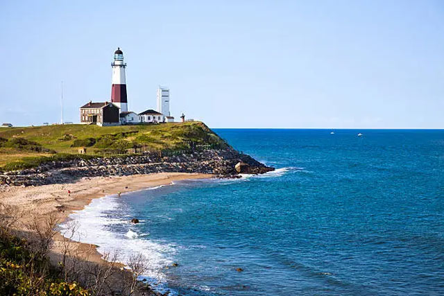 View of the Montauk Point lighthouse and the Atlantic Ocean in the distance.